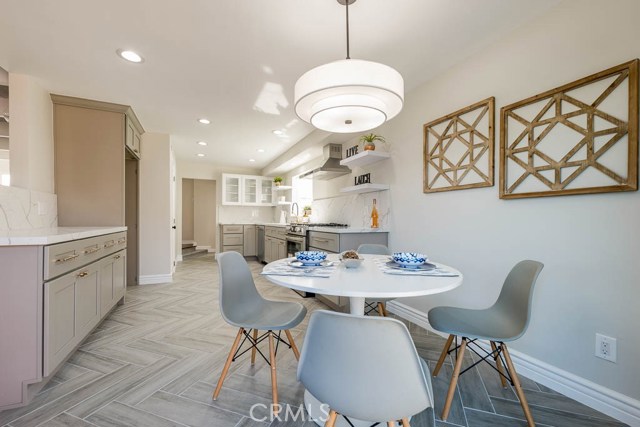 Stunning gourmet kitchen, with recessed lights, grey shaker cabinets, a huge pantry, tile floors, stainless steel appliances and quartz counters