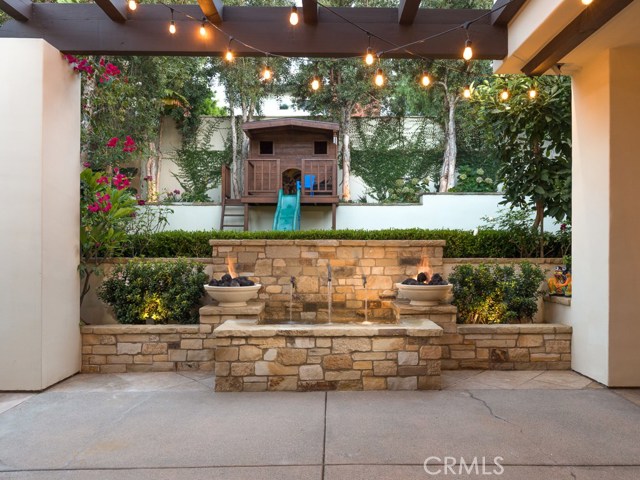 Twilight fountain and play house.