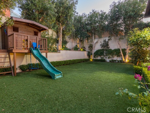 Expansive yard with play house.