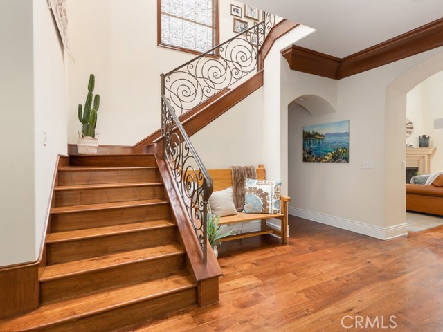 Staircase to the upper 4 bedrooms and entrance to lower bedroom, garage and courtyard.