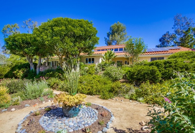 Landscaped southern yard with view of house