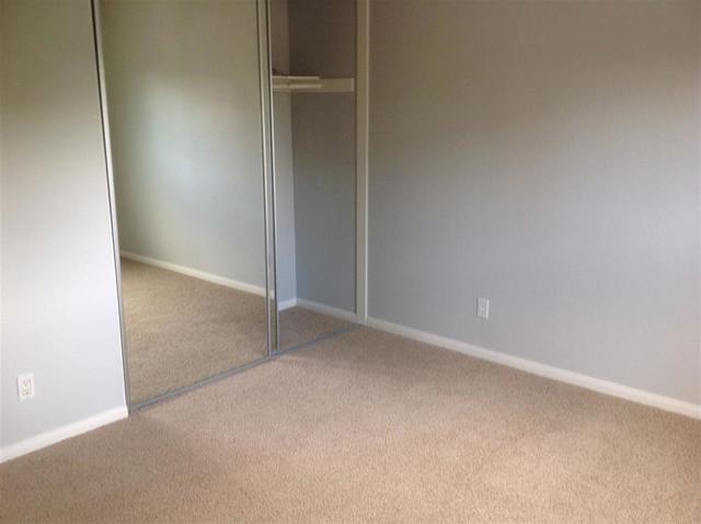 2nd Bedroom with floor to ceiling mirrored closet doors.