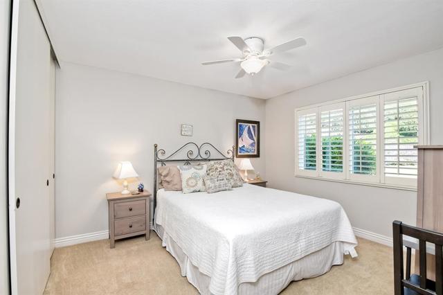 Secondary bedroom - views from the window to open space garden. Wall to wall closets.