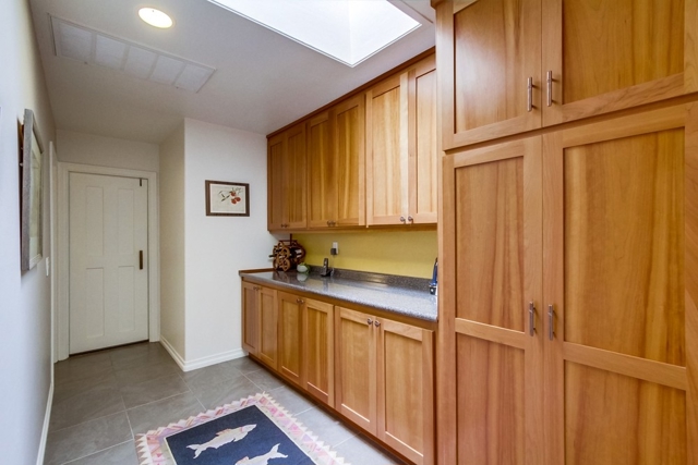 Hallway storage near door to garage and guest bedrooms