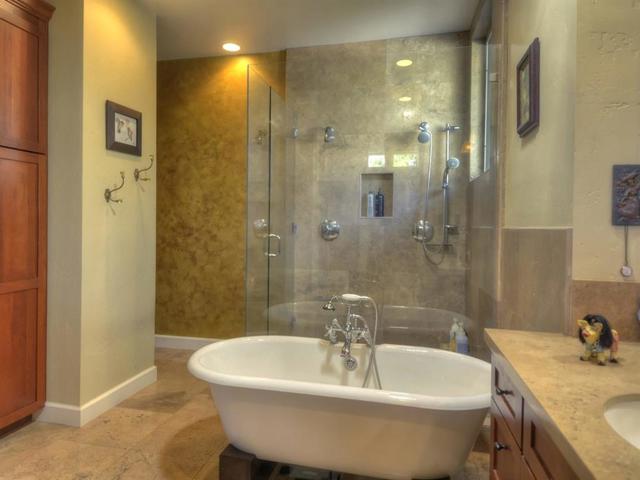 Separate tub & glass enclosed shower with 3 shower heads