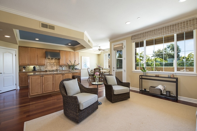 This spacious living room opens to the kitchen and is an entertainment dream.