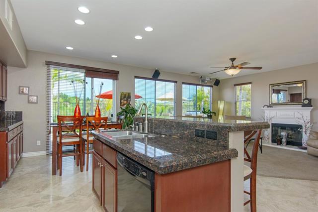 The gourmet kitchen opens to the family room & breakfast area.  PANORAMIC back yard VIEW!