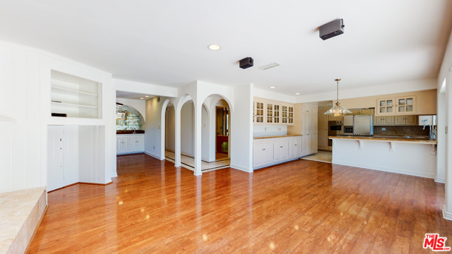 Family room facing bonus room on left and kitchen on right