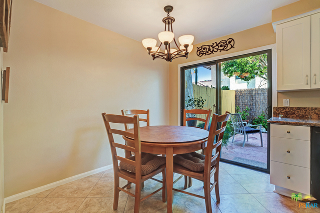 Dining area looks out to greenery and pa