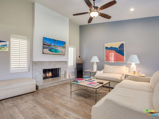 Living room with fireplace and high ceilings