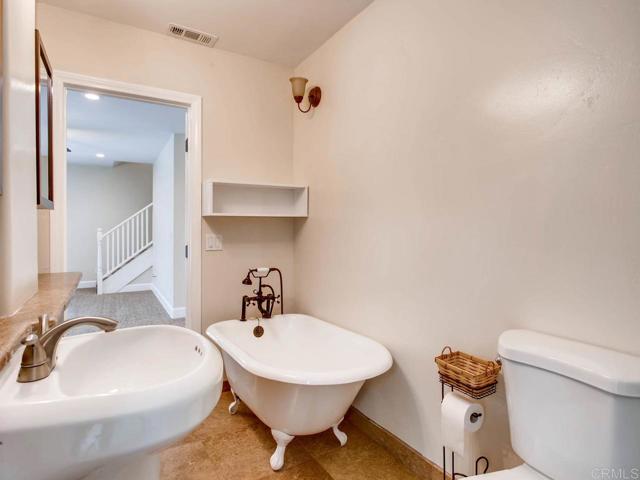 Downstairs bathroom with bath tub and walk-in shower.