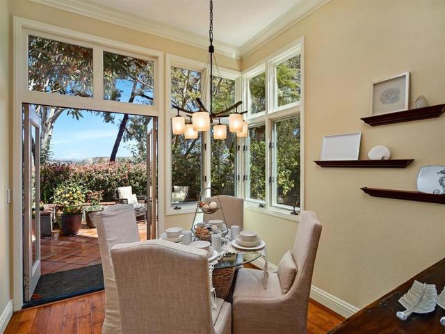 Breakfast area with French doors to outdoor living, grilling, and night time city lights.