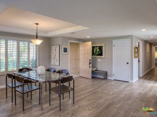 Doorway entry to living room with plantation shutters throughout