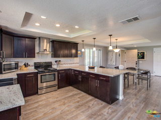 Kitchen is open concept with slider door to patio