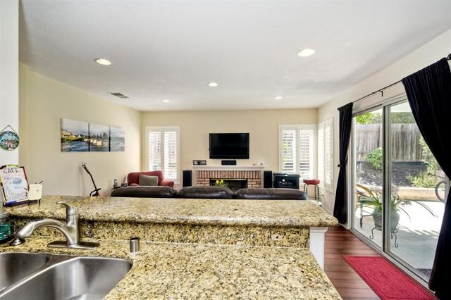 View to the family room from the kitchen. Slider to the beautiful, private backyard!