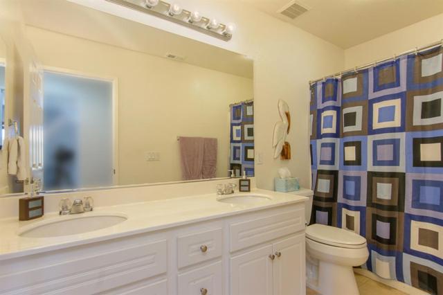 Notice the double sinks in this upstairs hall bathroom.