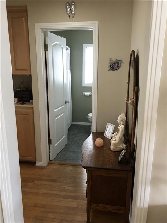 Living room looking into hallway towards bathroom.