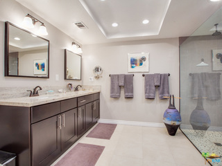 Master bathroom with dual sinks and tile floors