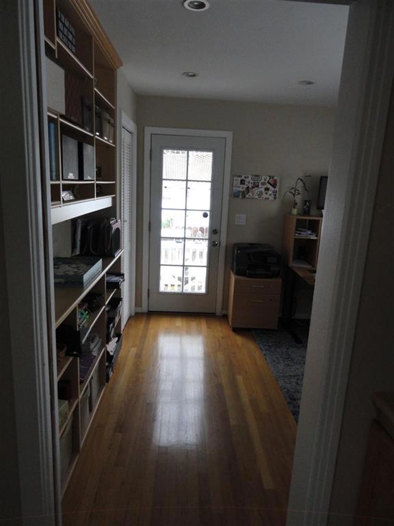 Hallway looking into 2nd bedroom. Looking towards back door out to patio.