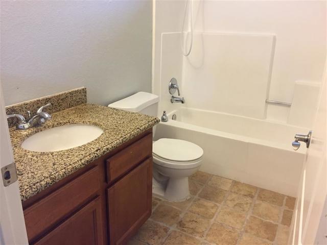 Hall Bath with tile floor and granite counter top vanity.