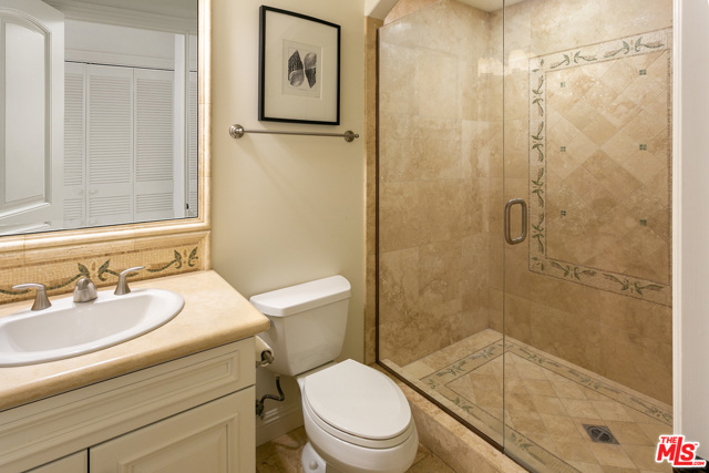 Baroom wi mosaic design shower, marble vanity sink & travertine floors (st floor).