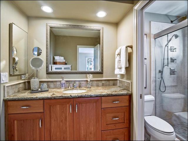 Secondary bathroom connects to the guest bedroom and includes access from the hallway for multiple use.