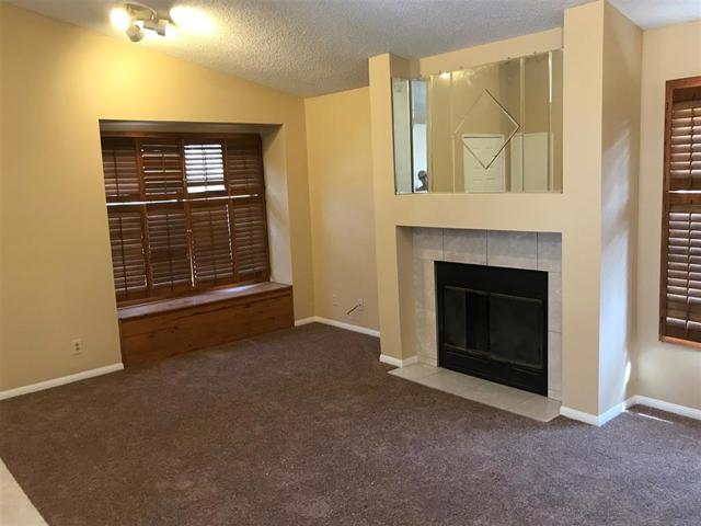 Very warm welcoming living room with a fireplace for those colder days of Fall, Winter, and some Spring days in Murrieta. New carpet and paint as well.