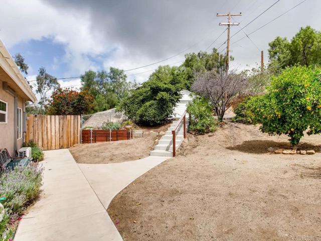 Exterior side of home with pathway to garage.