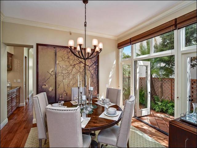 Dining Room with French doors leading outside. Listen to the ocean breezes, and enjoy easy access to the kitchen or outdoor grilling while dining with friends and family!