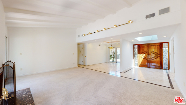 Living room facing front door and dining room