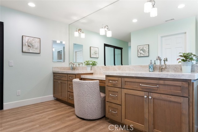 The primary bathroom has been thoughtfully layout with dual sinks, full length mirror that runs the entire length of the counter top, strategically placed lighting, make-up vanity and so much more.