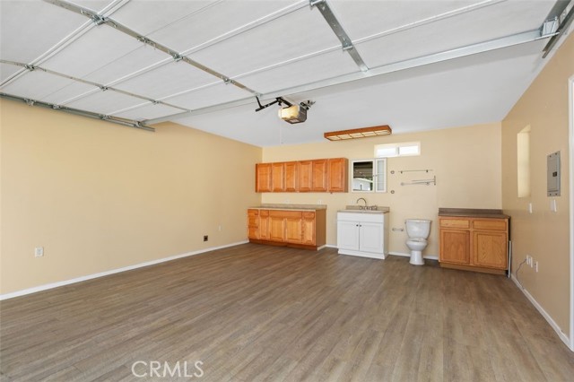 Finished garage with a water heater, sink, and commode (buyer to check permits)