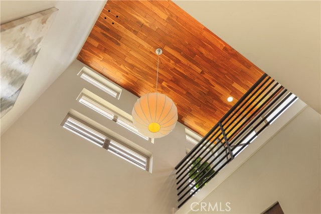 Striking hard wood ceiling in entry way adding warmth to this modern coastal beauty.