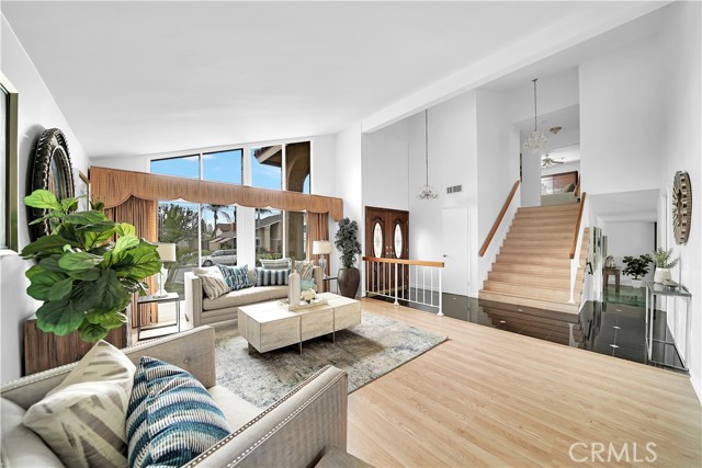 As you make your way upstairs, you'll notice the wide staircase and custom chandeliers, adding to the luxurious feel of this home.