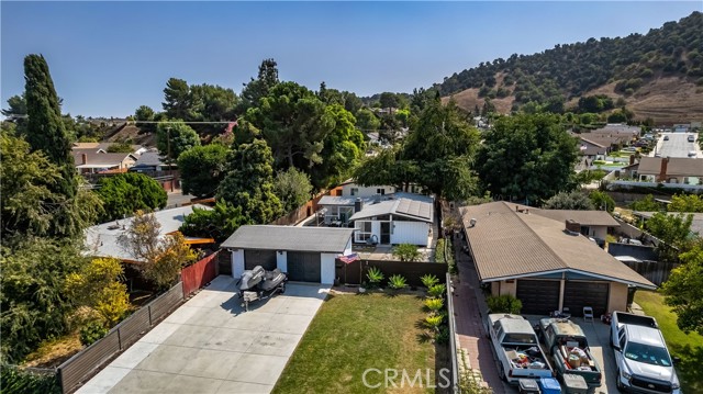 Aerial view of massive driveway, 2 car garage, primary home and ADU