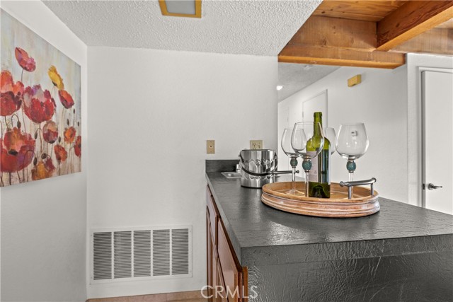 This convenient wet bar makes great for entertaining!  It presents itself with a small sink, and lots of cabinets underneath.