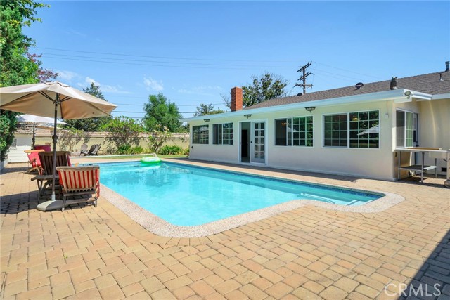 Expansive pavered pool deck.  That's the Sun Room too!