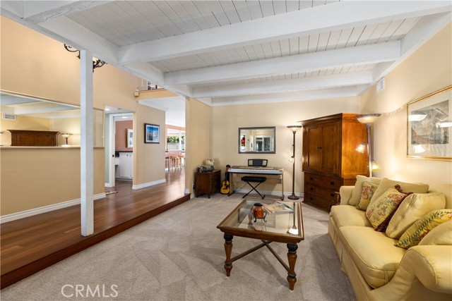 Formal living room with fireplace, new carpeting, and new paint.