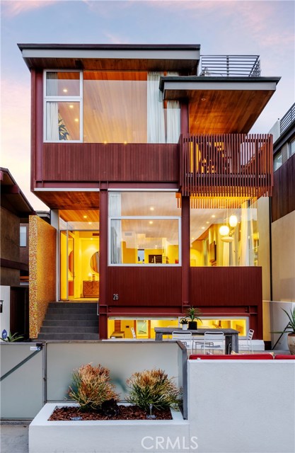 26 9th Street Hermosa Beach, California To view a 3D home tour go to https://bit.ly/26NinthHomeTour --Welcome to the endless summer! Located just a few steps from the strand and sandy beach and a hop away from downtown Hermosa Beach, this contemporary masterpiece was designed by architect Robert Thibodeau of Du Architects in 2009. Bathe in the sun and lounge in the sea breeze in the glorious amenities of this 5 bedroom, 4.5 bathroom beauty that sits on an over-sized walk-street lot. Have you always wanted gourmet European-style kitchen? Now you have one complete with custom German cabinetry, Miele appliances, and a walk-in pantry. Ocean breeze a bit too chilly? Well you have 3 fireplaces, dual zone AC, premium hardwood floors, natural stone finishes, and dramatic 13 foot vaulted redwood ceilings to combat the cool and the heat. Main suite comes complete with stunning ocean views, his & hers walk-in-closets, beautiful master bath with radiant heated floors, steam shower, and a spa tub adjacent to a two sided romantic fireplace whose window pivots open to an ocean view deck. The bottom floor is a complete home theater with projection screen and wet bar. There is a 3- stop elevator and rooftop deck for those stunning Pacific sunsets. Bonus points for the 5 car off-street parking and modern audio visual system throughout the entire house. Toast to the day in the front yard with a lit fire pit that is perfect for dinner parties, evening cocktails or just soaking in the sun as the ocean sparkles in the background!