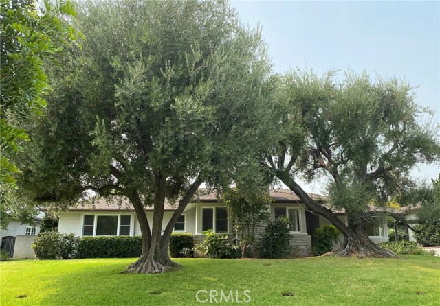 1635 Old Mill Road San Marino, California WELCOME HOME to this lovely Traditional/Mid-Century home! The wide front door opens to the Formal Entry with beautiful Hardwood Floors. From here you can go to the generous size Living Room with a Fireplace and corner windows overlooking the gorgeous mature trees; the spacious Formal Dining Room or the large Family Room which boasts a second Fireplace, walls of Built-In cabinets and a Sliding Glass Door looking out on the Patio and Terraced Yards. The Kitchen offers tons of Cabinets and Counter Space, a Built-In Double Oven, Cook-Top and New Dishwasher. Between the Kitchen and Back Door is the Laundry Room with even more Storage! The Master Suite features a Dressing Area with Mirrored closet doors and an en-suite 3/4 Bath. The Full Hall Bath has a separate Stall Shower in addition to the Bathtub and is flanked by Bedrooms Two and Three, both with Wardrobe Closets and a view of the back yard. As if this isn't enough - there is a detached Studio with 3/4 Bath! Imagine the possibilities - home office; bedroom four; game room just to name a few ideas. This Beauty is close to Top Rated Schools, the Huntington Library, Lacy Park, Restaurants, Shopping and Transportation.