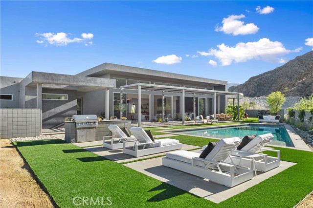 50067 Canyon View Drive Palm Desert, California Nestled in the luxury custom home development of Ironwood Country Club, this rare new construction exemplifies the ultimate spirit of desert lifestyle real estate. Thoughtfully balanced designer features and natural elements add to the already solidified prestige of South Palm Desert's most coveted mountain communities. With its sensational entry and intimate mountain views, this private, contemporary new construction is both classic and serene. The front entry opens to a spacious yard with custom built bbq, pool, spa and outdoor shower, and large trellis for entertaining. Rich, colorful landscape and exterior tile and paved stones surround the space with 360 mountain views in the background. The home's main living area, which comprises living, dining, and kitchen, looks out to dramatic mountain views through an expansive wall of floor to ceiling glass. Highlights include tall ceilings, dual room fireplace, and sleek, modern appliances. Through the living and family room are three spacious en-suite bedrooms with the primary room boasting a large, luxurious bath with soak tub and modern finishes. Two spacious walk-in closets separate the bath and bedroom. Also in the primary bedroom are spectacular mountain views through private patio sliding glass doors, custom fireplace and media detail. This community offers the charm and allure of a traditional desert escape paired with many highly sought-after amenities and club offerings such as two championship caliber 18-hole golf courses, tennis & pickle ball, spa, health and wellness programs, wine club and gourmet cuisine, and more. Plans approved by HOA for ADU. ********
