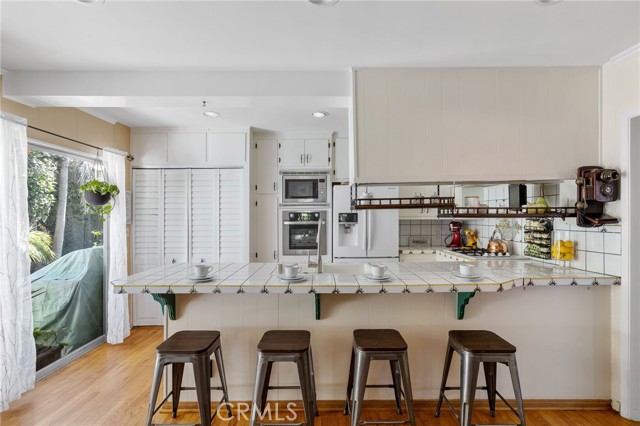 Breakfast bar is a great spot for guests to hang out as you prep and entertain from the kitchen.