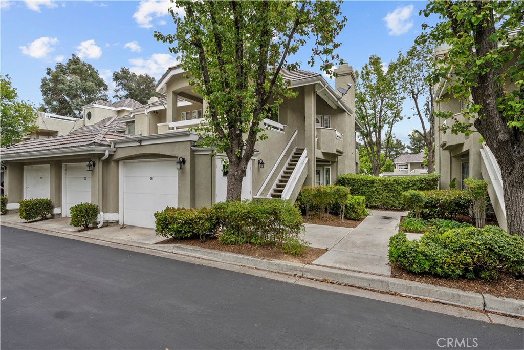 Lovely lower-level 2-bedroom, 2-bath condo in the desirable gated community of Arbor Park! Offering 1,154 sq. ft. of living space, this home features porcelain tile flooring throughout (no carpet), quartz countertops, a stylish backsplash, and a newer dishwasher in the kitchen. The private back patio has no direct rear neighbors and backs up to the community pool for added privacy. Enjoy the convenience of an attached one-car garage and community amenities including a pool, spa, picnic area, and well-maintained grounds—all with no Mello-Roos tax. Arbor Park is tucked away from busy McBean Parkway, adjacent to a recreational tennis park and the scenic Summit neighborhood. Close to the 5 Freeway, College of the Canyons, CalArts, shopping, dining, and top-rated schools—this is a fantastic opportunity to own in one of Valencia’s most sought-after areas!