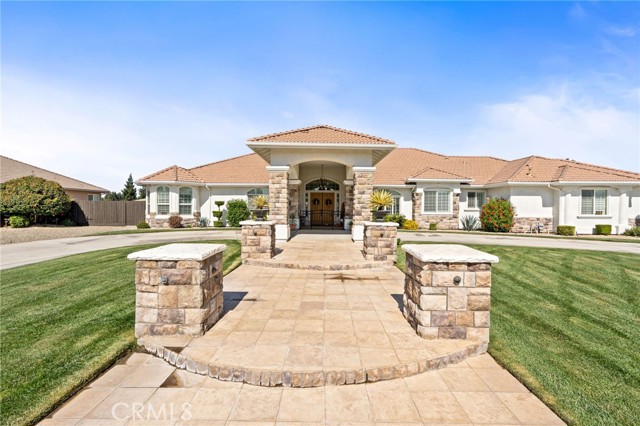 Travertine tile steps lead to the front entry