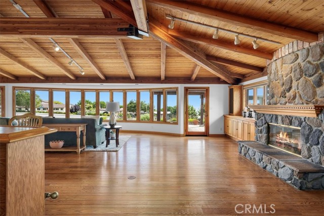 Living Room featuring expansive windows, providing abundant, natural light, along with sunrise and ocean views.