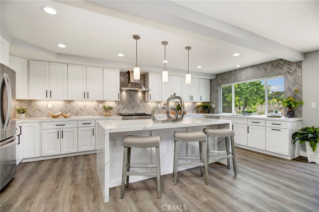 Extensively Remodeled Custom 5 bedroom, 3 bath home w/900 sq. ft. 3 car garage & workshop. CDS location, flat 10,500 sq. ft. lot w/8’ gate to side yard & huge back yard.  Main floor bedroom & large ¾ bath. Open floor plan w/great room concept. Enlarged & reconfigured kitchen w/white shaker cabinets, self-closing drawers/doors & matte black hardware. Calcatta Laza Quartz counter tops & double waterfall island. ALL NEW ZLINE stainless steel appliances, 36" Professional Gas 6 Burner Range, Hood, Microwave Drawer & Dishwasher. KOHLER Semiprofessional brushed nickel faucet, under cabinet lighting & blown glass pendant lights.  Reconfigured & Remodeled Master Bath w/ barn door entry, 6’ x 6.5' wet room surrounded in 24” x 48” marble look tile, frameless glass enclosure, free standing tub w/matte black freestanding faucet.  90” white shaker style dual vanity, self-closing drawers/doors, Calcatta Laza Quartz counter top, square black framed mirrors, recessed lighting & blown glass pendant light, & matte black hardware, faucets, shower valve, shower head & matching towel bar. Large walk-in closet.  All remodeled & highly upgraded bathrooms.  Oversize indoor laundry room w/shaker cabinets, quartz counter tops & laundry sink.  ALL NEW dual pane vinyl windows/doors, PEX repipe, paint in/out, ext/interior doors, base, case, hardware, lighting, sprinkler system, sod, landscaping.  9” plank waterproof flooring throughout.  Complete list of improvements available in the listing supplements.