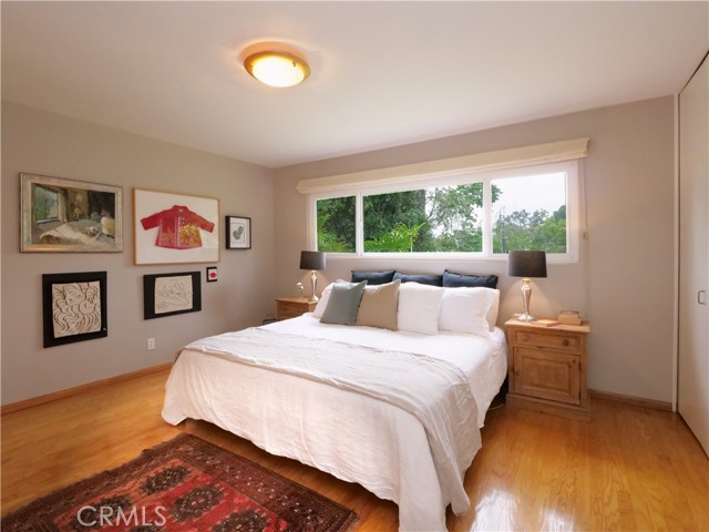 Main level primary bedroom with view to the private backyard