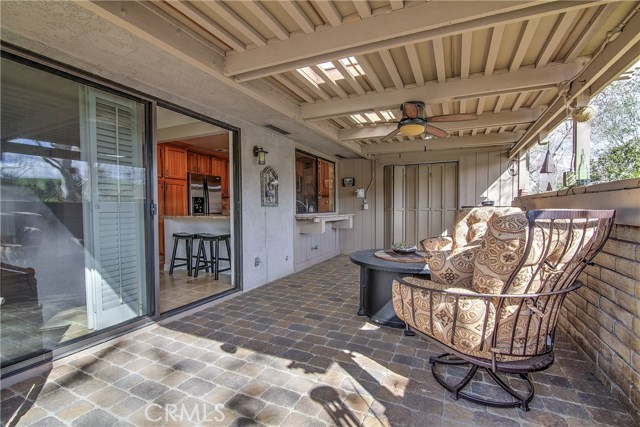 Expansive patio #1 with pavers, covered area with openings to allow lighting. Ceiling fan and lighting add to this outdoor living space.