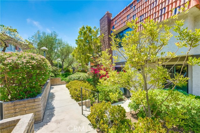 Front walkway to unit. Lush landscaping.