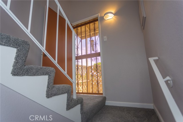 Staircase with access to side yard, security door and stairs outside
